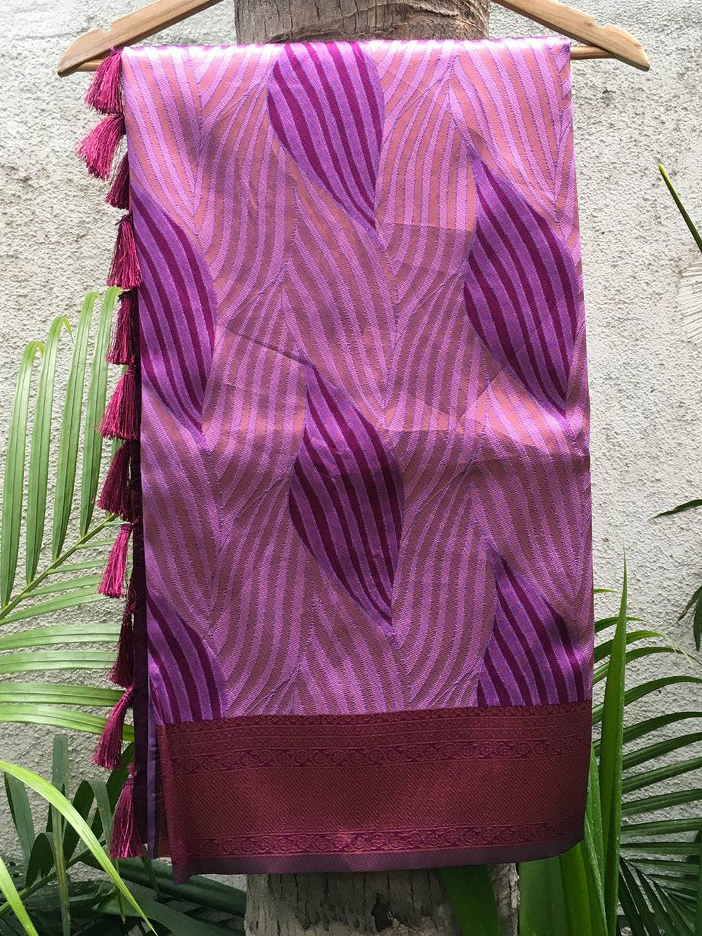 Lavender tussar silk ikkat saree draped over hanger