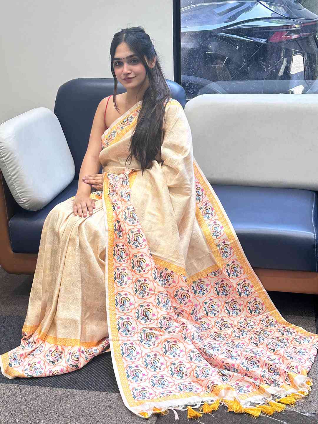Cream Kanjivaram saree with Patola print draped elegantly