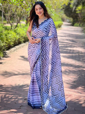 Model showcasing Leheriya and striped print saree on pathway
