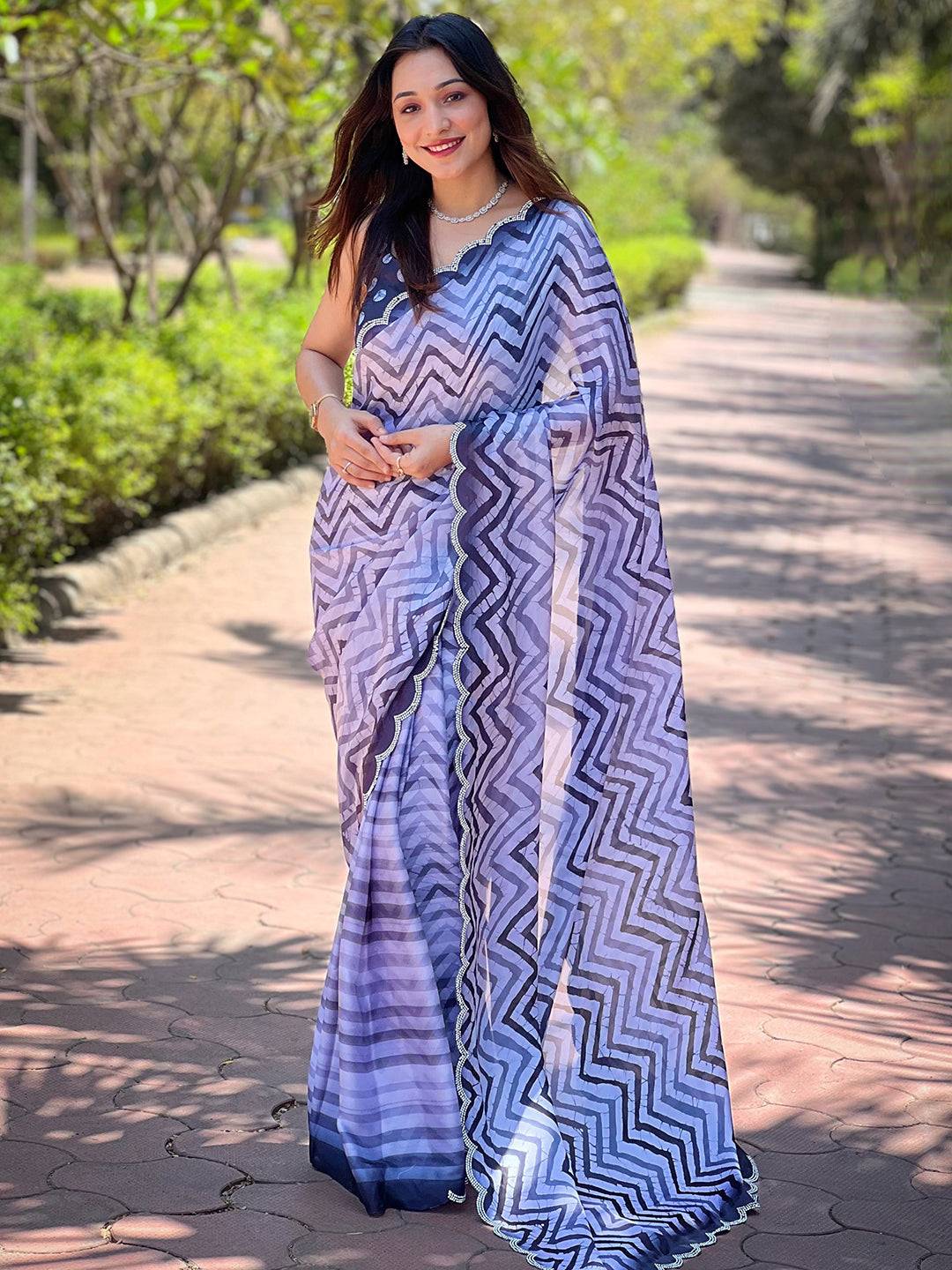 Model showcasing Leheriya and striped print saree on pathway