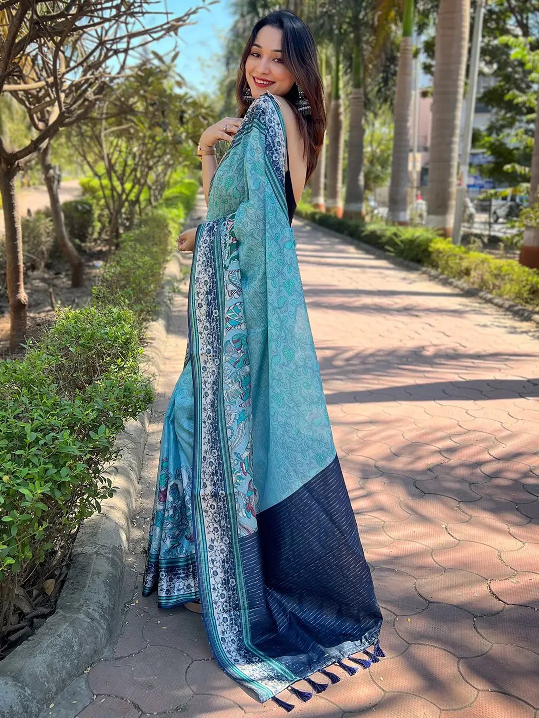 Side view of model in Satin Kota Doria Saree with Kalamkari print.