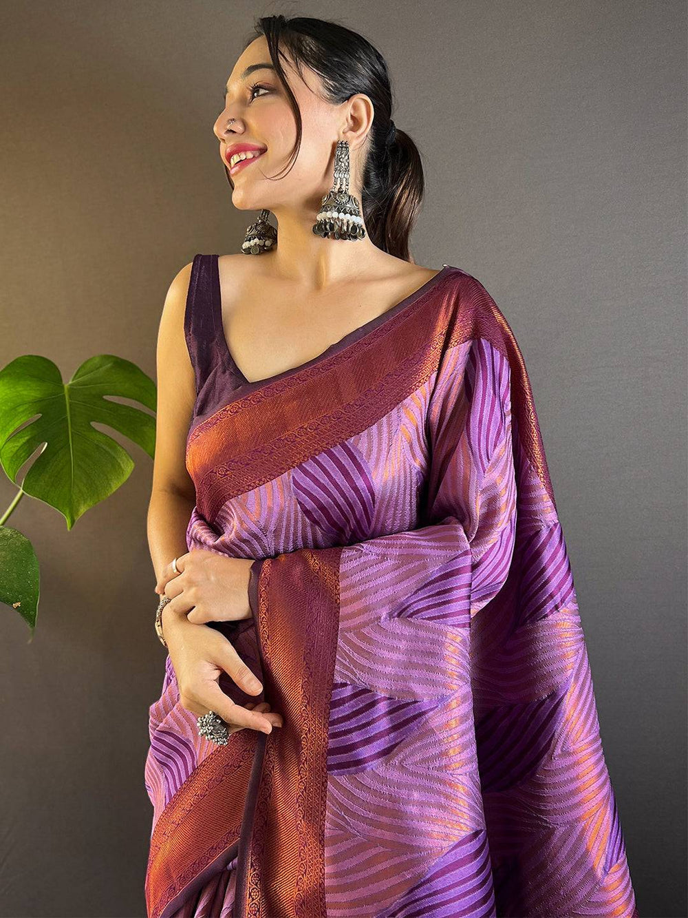 Model wearing lavender tussar silk ikkat saree with earrings