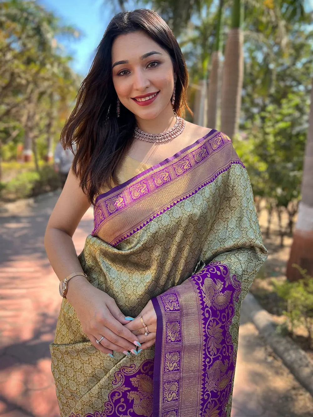 Model wearing gold Kanjivaram saree with intricate design