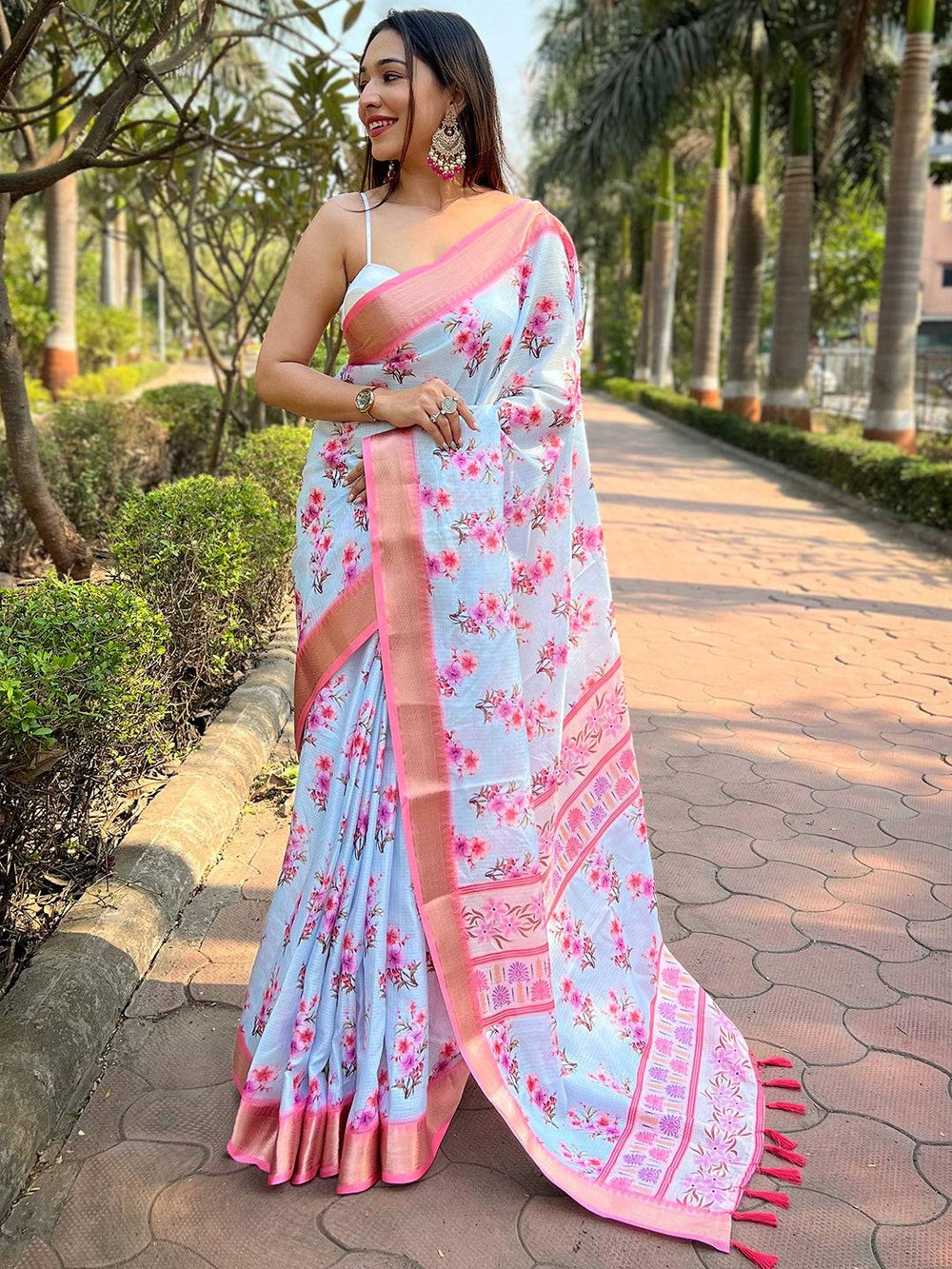 Light blue Kota saree with digital floral print, worn outdoors