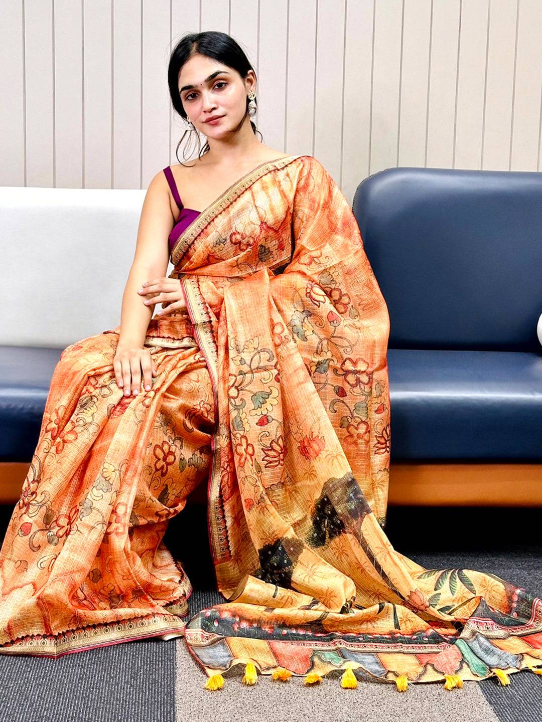 Orange Kota Doriya silk saree with floral print draped elegantly.
