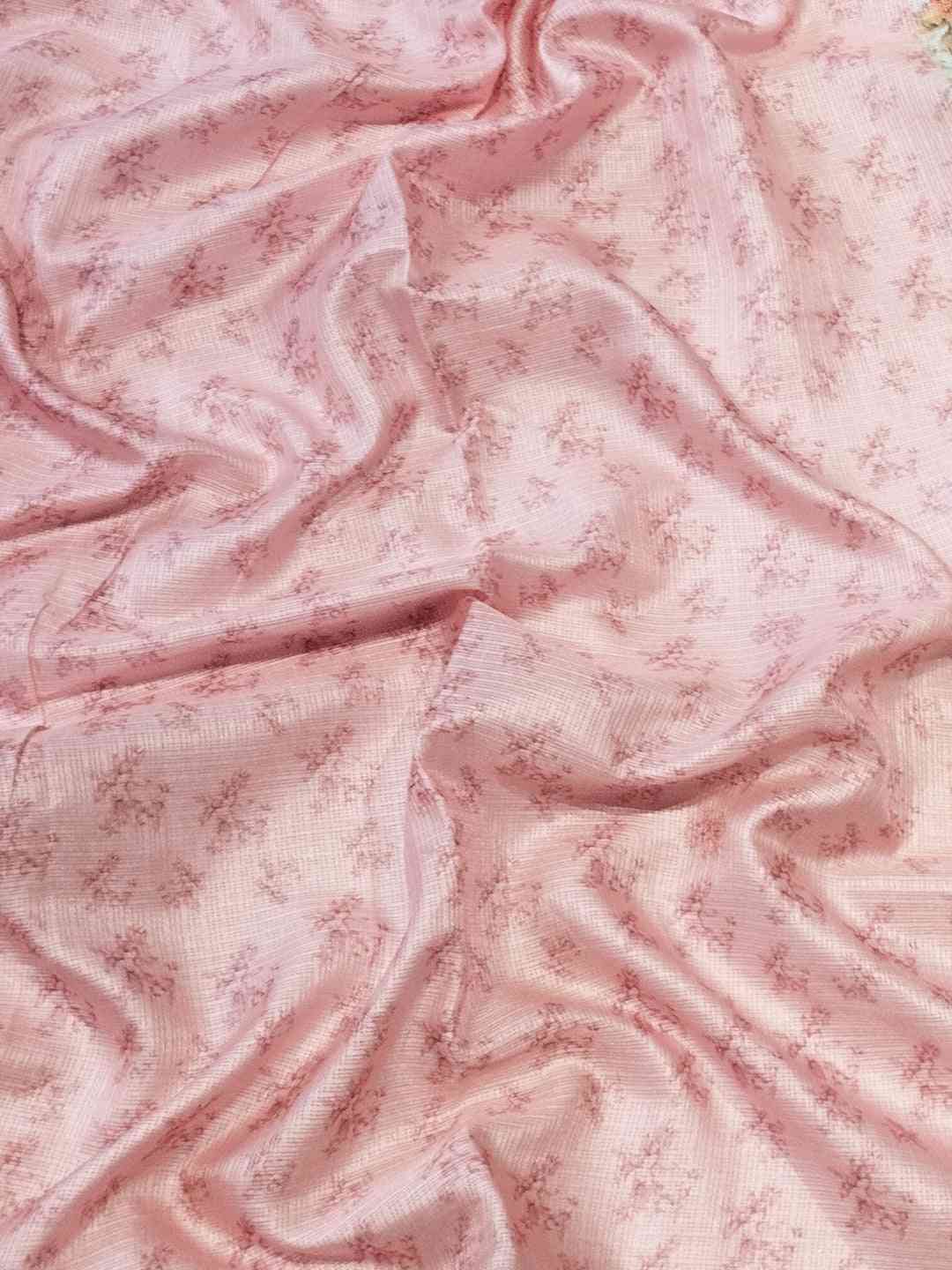 Soft pink fabric with subtle floral patterns.