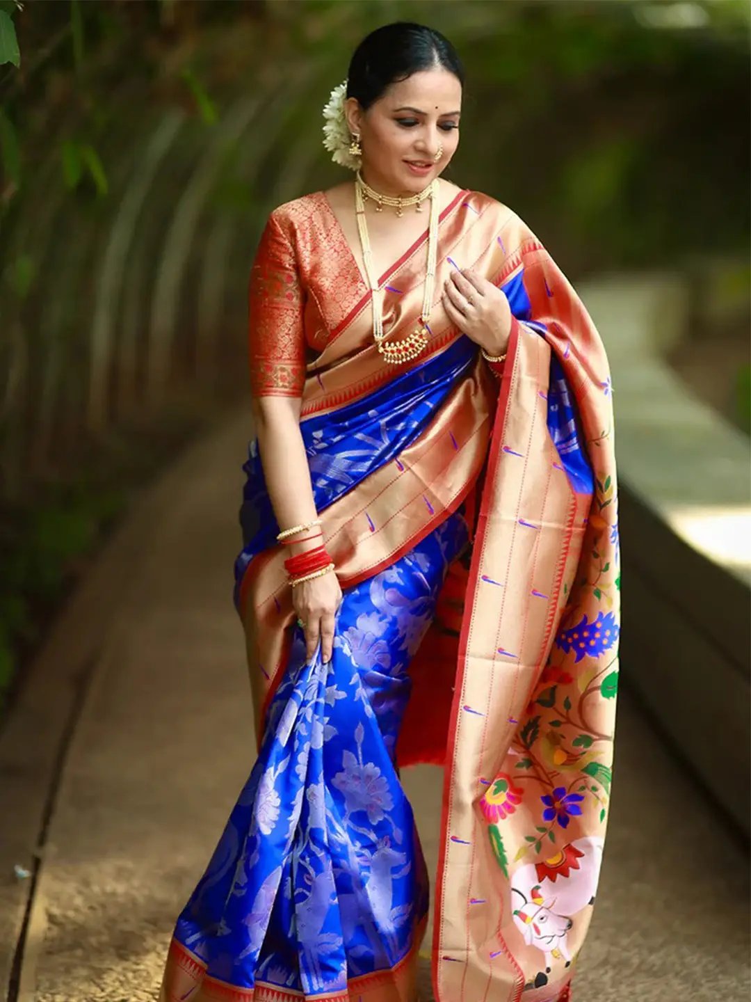 Royal blue Paithani saree featuring colorful pichwai motifs