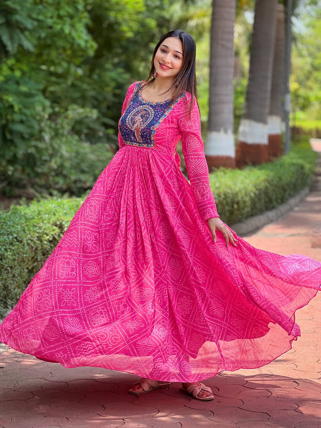 Flowing deep pink Bandhej print dress in outdoor setting.