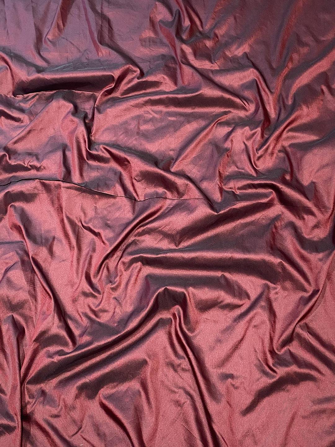 Close-up of maroon soft silk fabric with smooth texture
