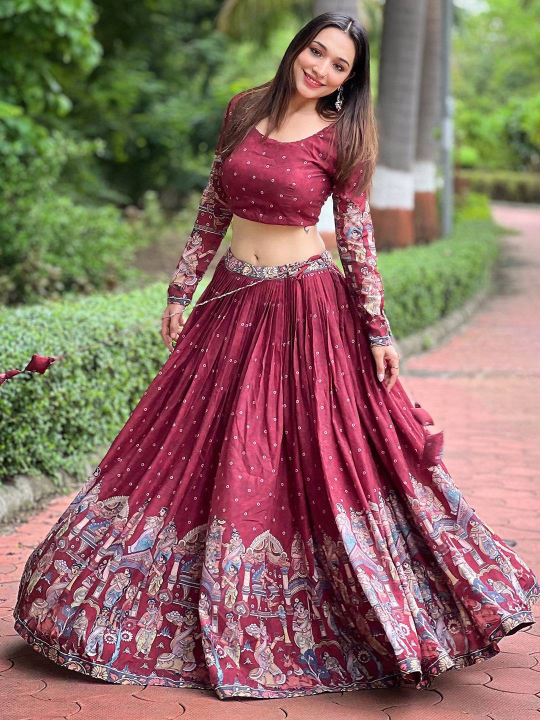 Model in deep maroon Kalamkari lehenga set on path