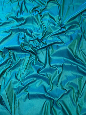 Close-up of green soft silk fabric with smooth texture