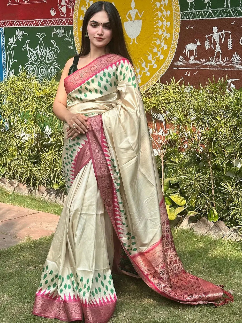 Elegant cream Banarasi silk saree with intricate Patola pallu