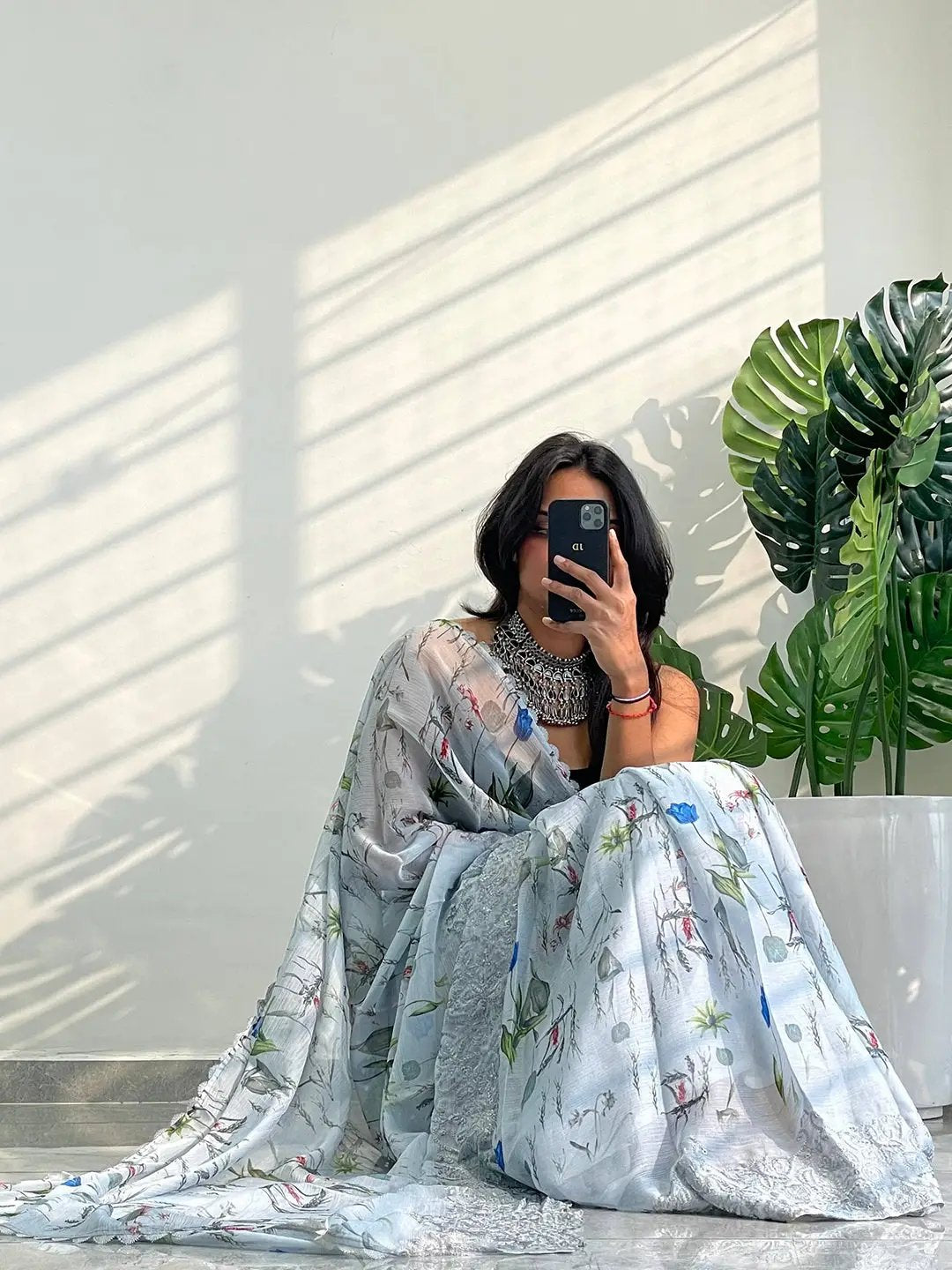 Chiffon satin saree draped elegantly with floral patterns