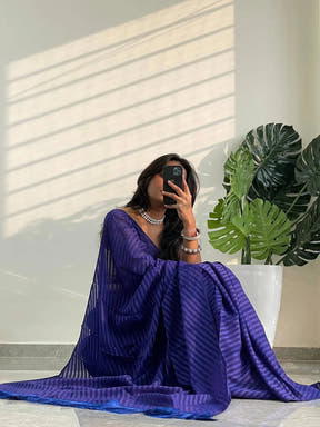 Model posing with blue georgette saree and thread weaving