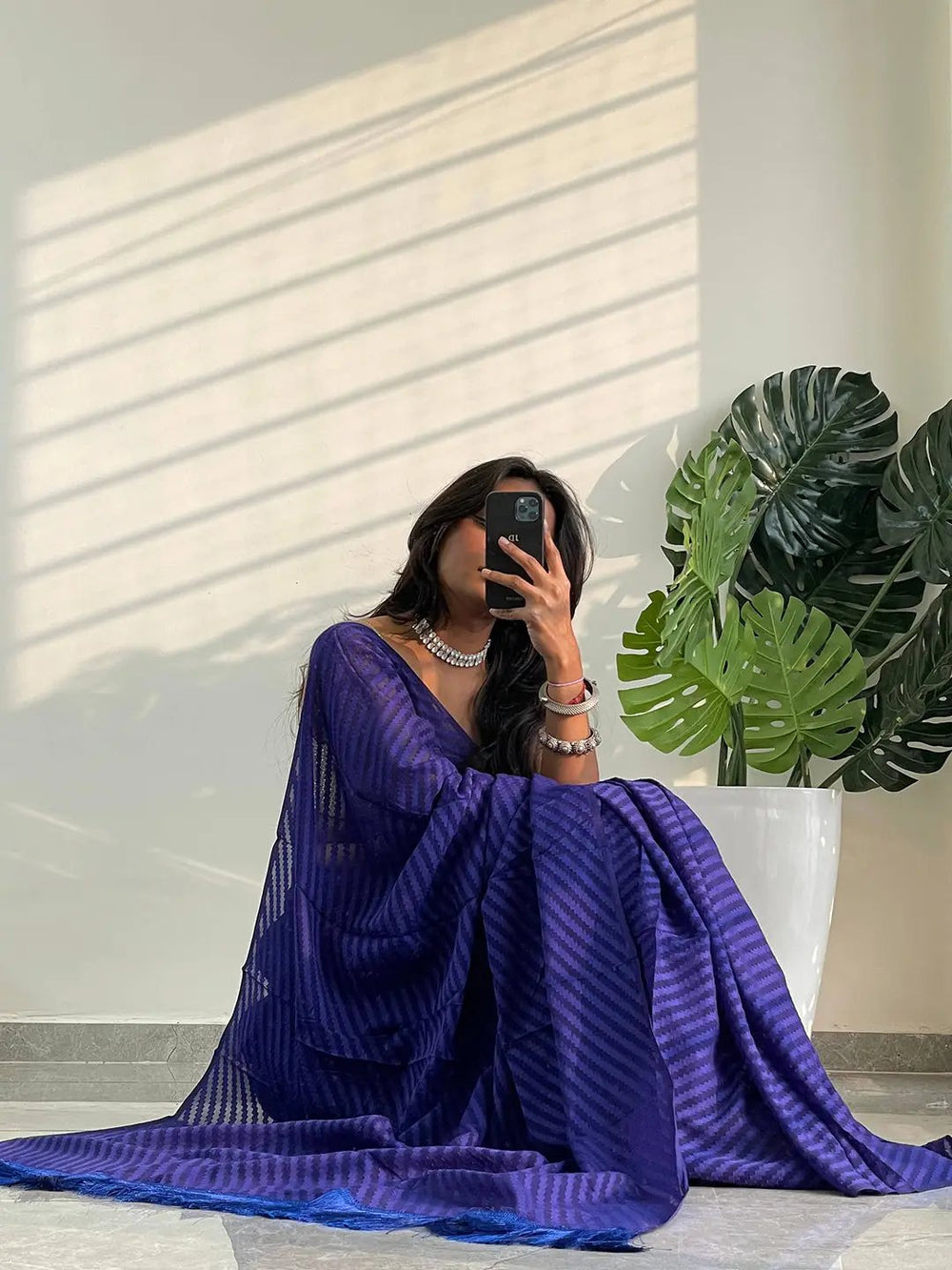 Model posing with blue georgette saree and thread weaving