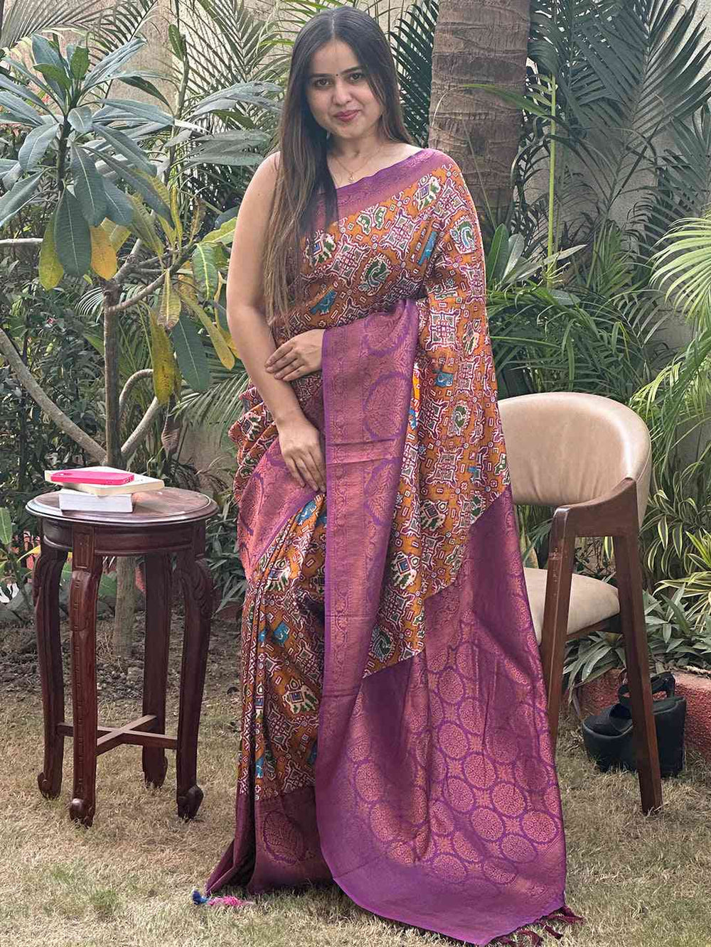 Model in vibrant purple Patola saree with detailed design