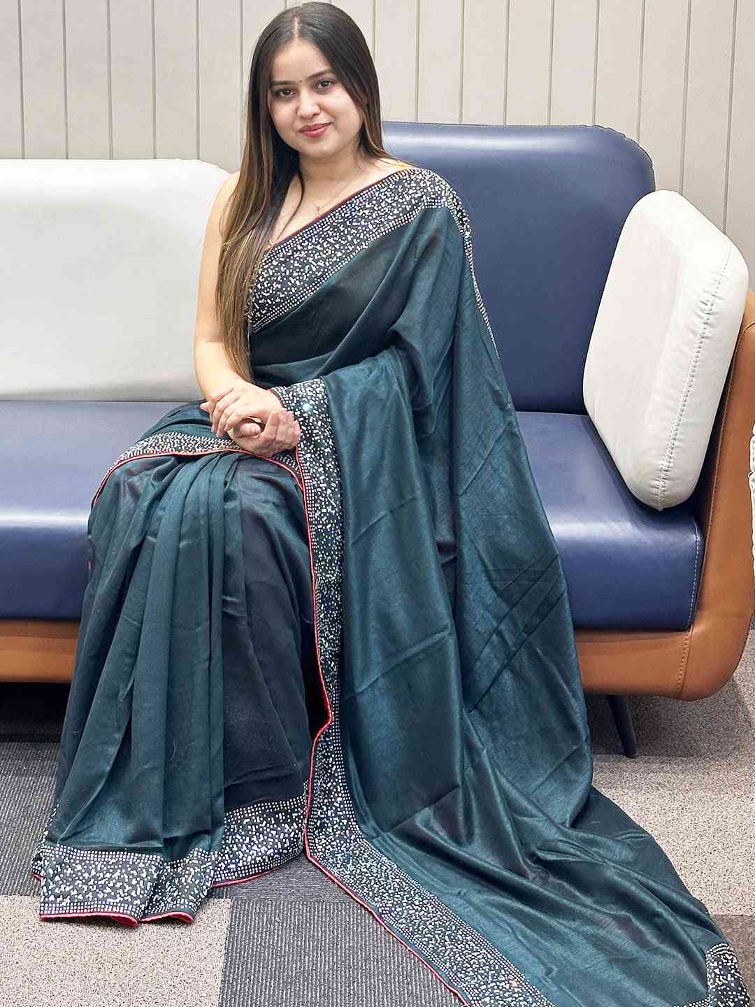 Dark green Vichitra silk saree with Swarovski stones, seated view