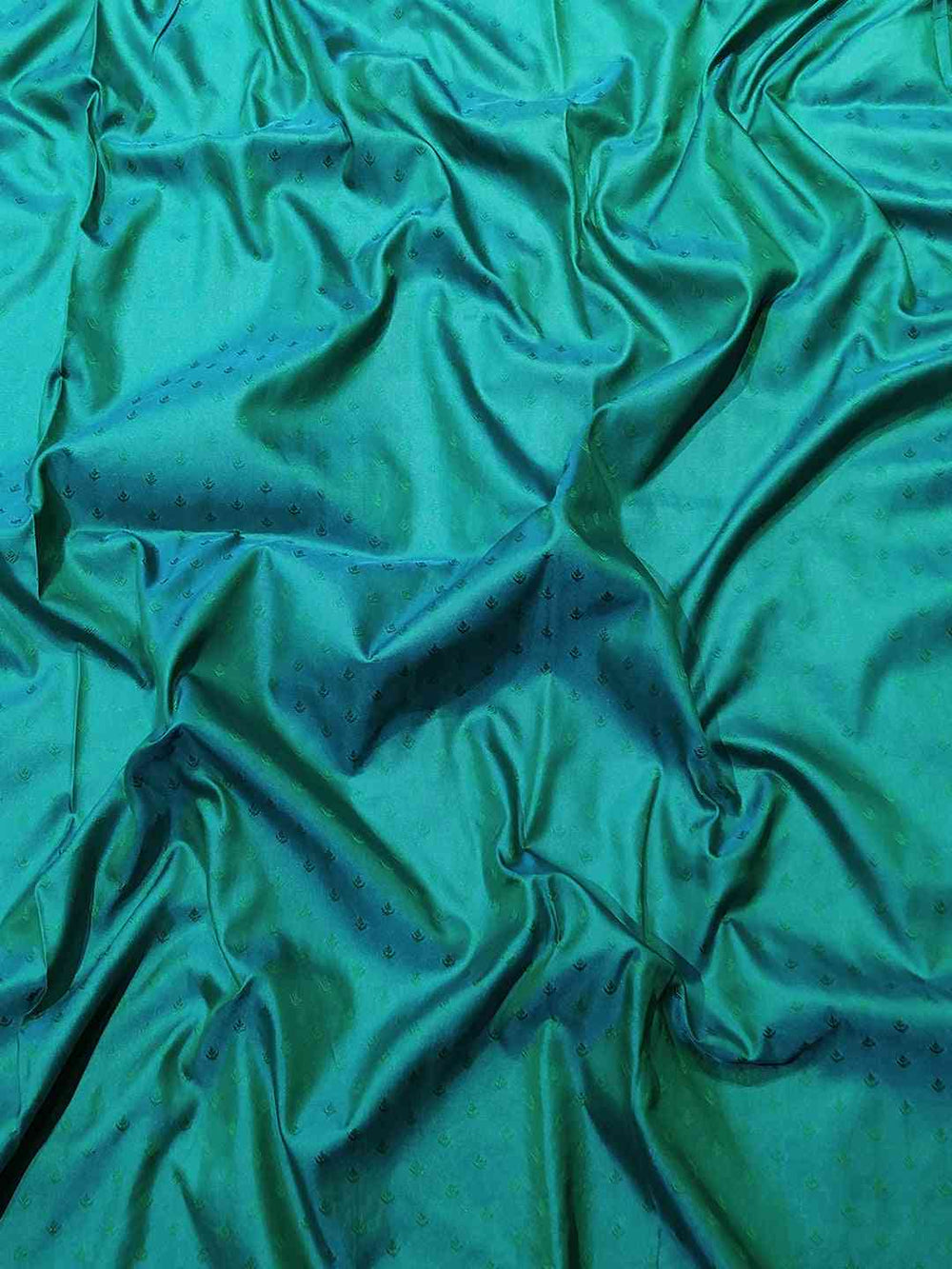 Rich green fabric of Kanjivaram silk saree with texture