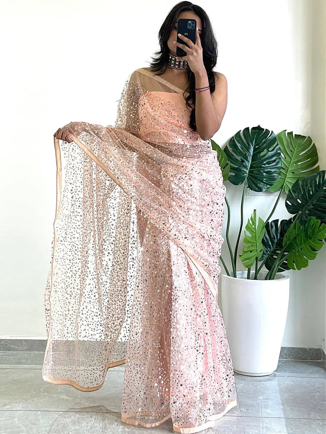 Stylish net saree with sequins embroidery, full view.