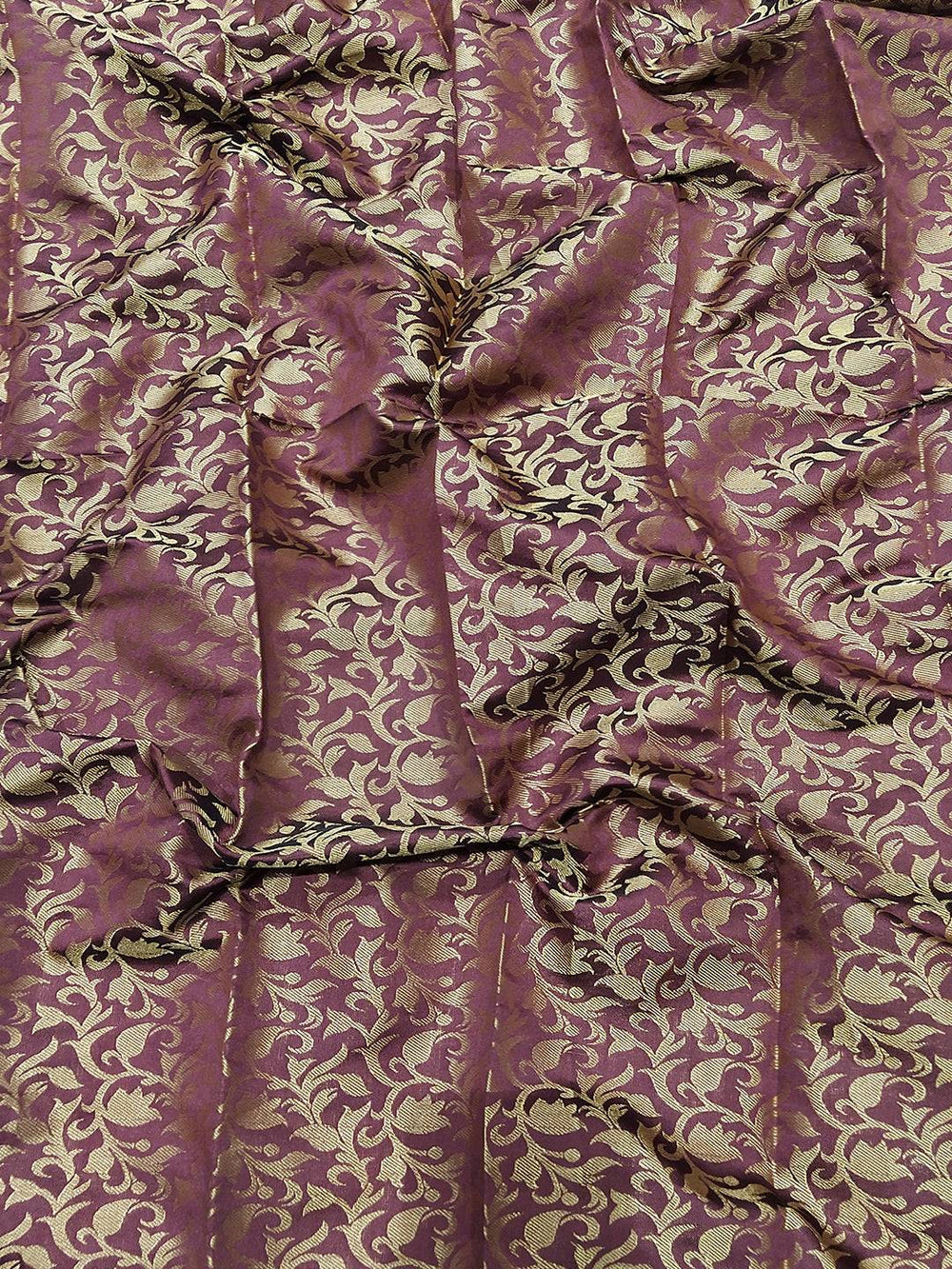 Close-up of gold and maroon Kanjivaram saree fabric