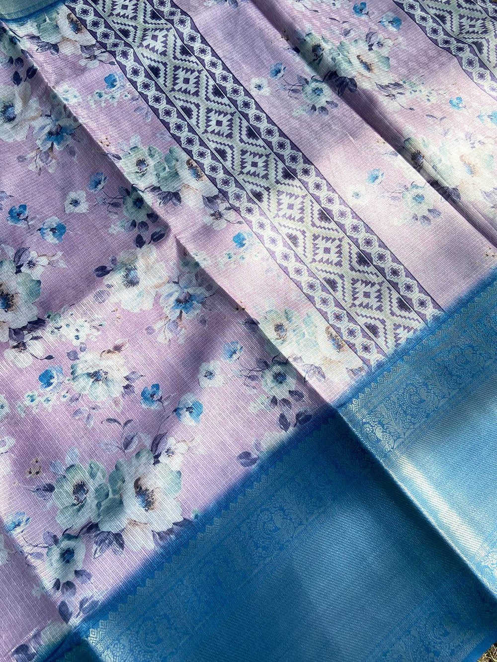 Close-up of floral print saree with intricate blue border