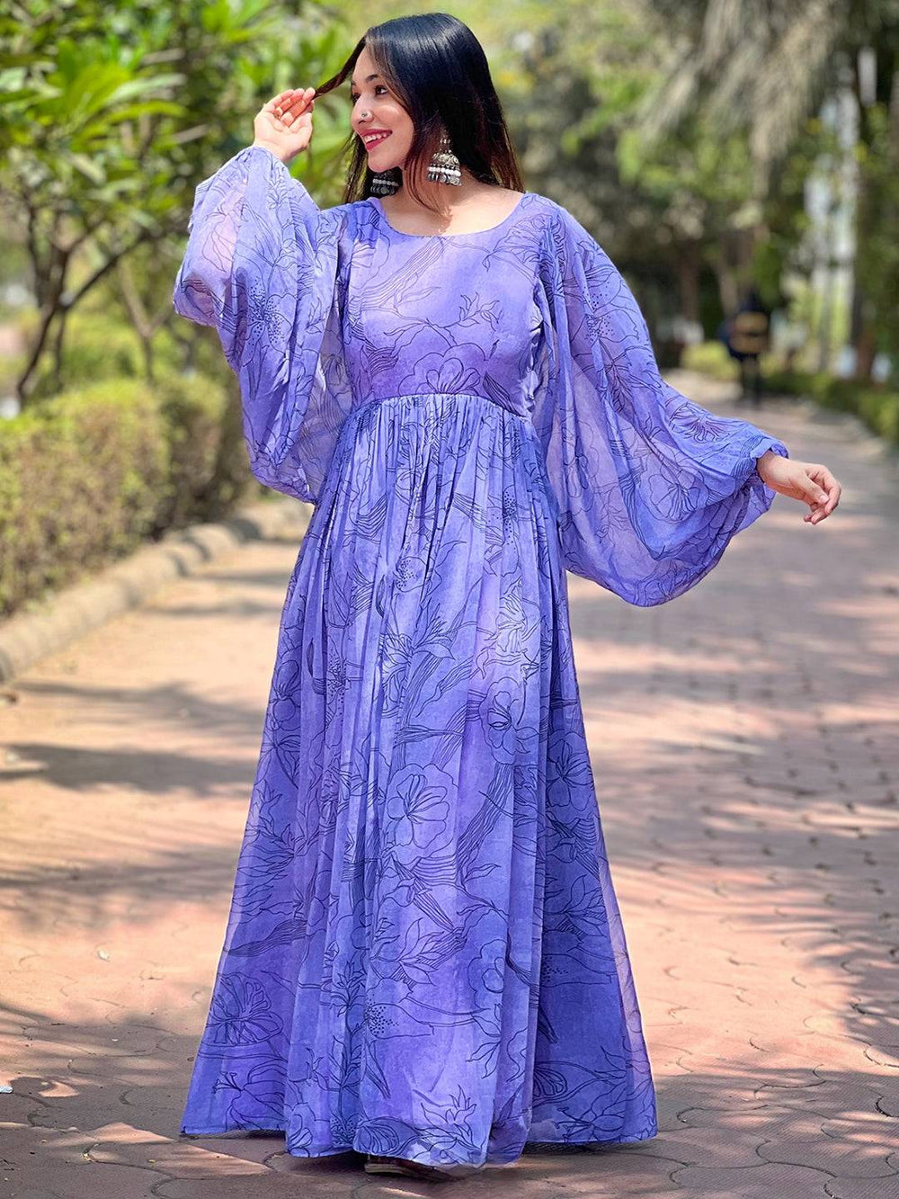 Woman in slate blue dolman puff sleeve dress outdoors