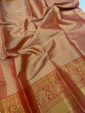 Close-up of gold zari Kanjivaaram pattu silk saree fabric details.