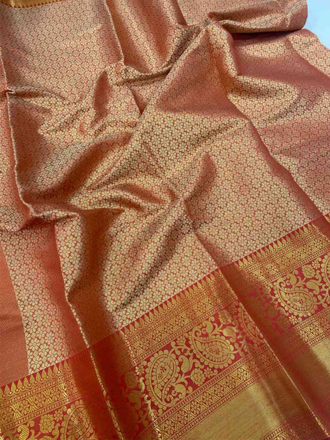 Close-up of gold zari Kanjivaaram pattu silk saree fabric details.