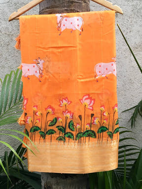 Orange organza saree with Pichwai print and zari border