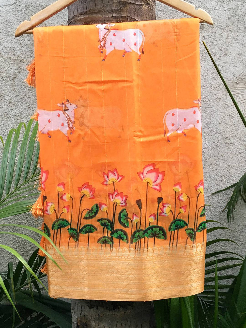 Orange organza saree with Pichwai print and zari border