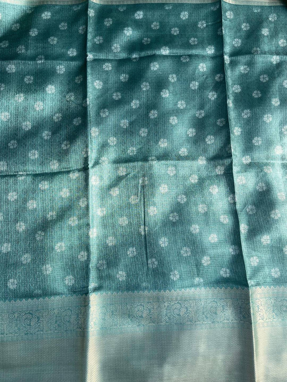 Teal patterned fabric with gold zari border on saree