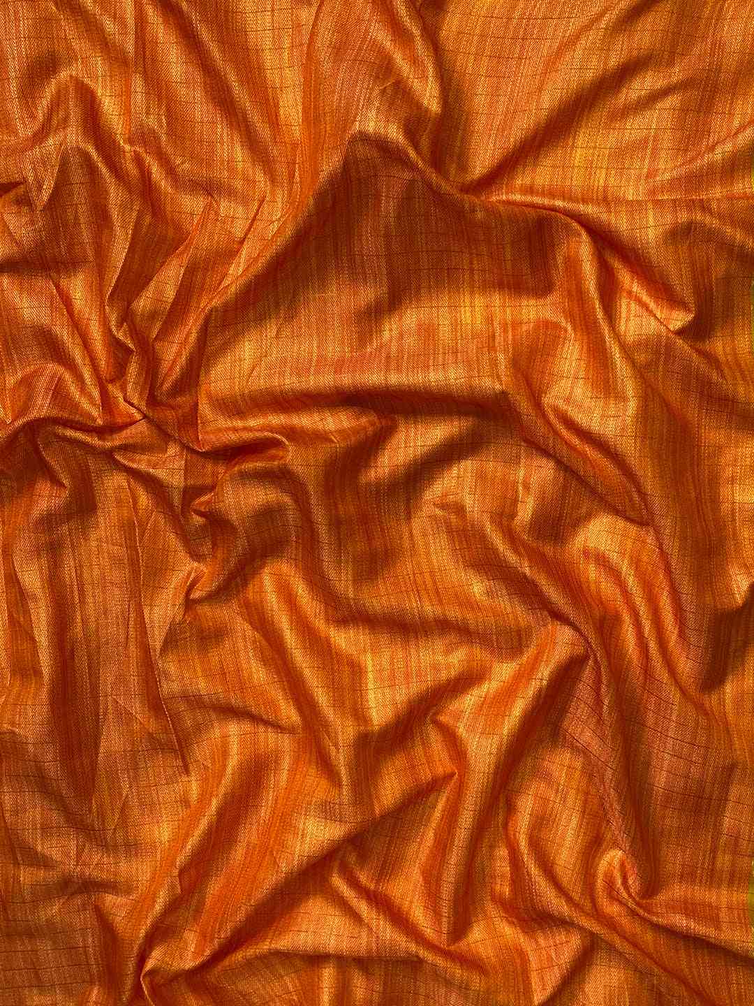 Close-up of orange silk fabric with fine texture