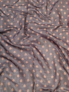 Close-up of red linen saree fabric with subtle patterns