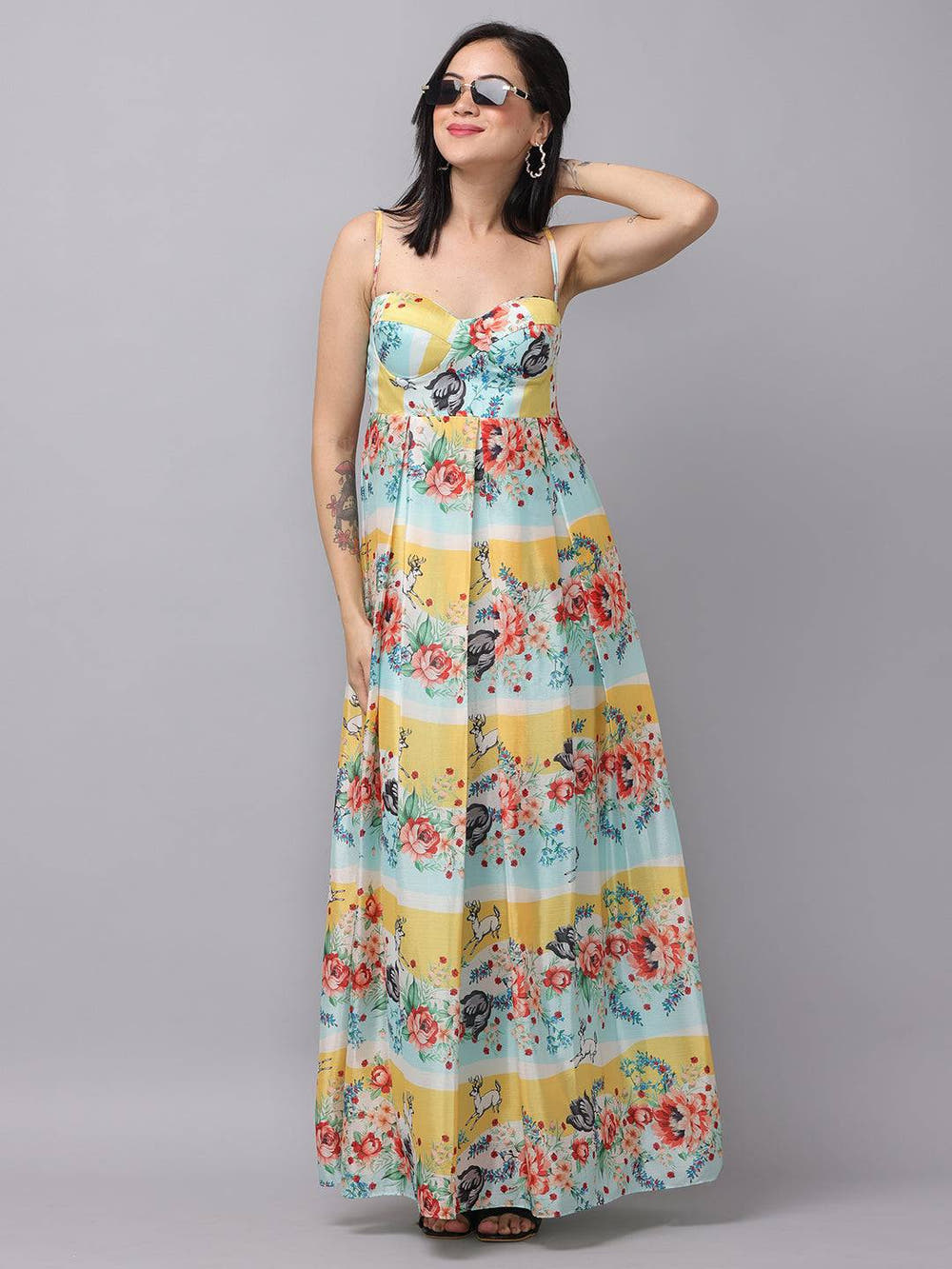Chiffon print sleeveless dress with floral design, model posing