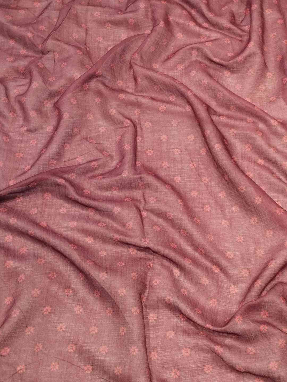 Close-up of fabric texture with subtle floral patterns