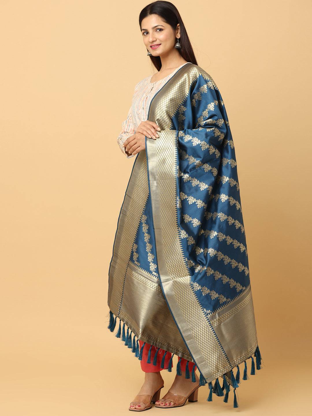 Side view of teal woven design dupatta with tassels