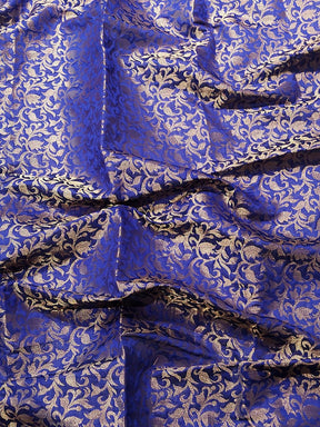 Close-up of blue brocade fabric with gold zari pattern