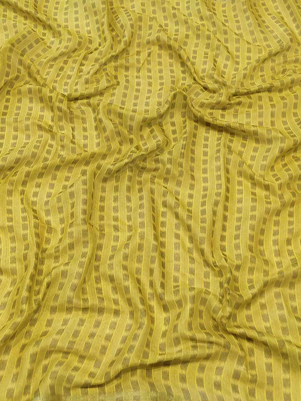 Close-up of yellow striped fabric from saree