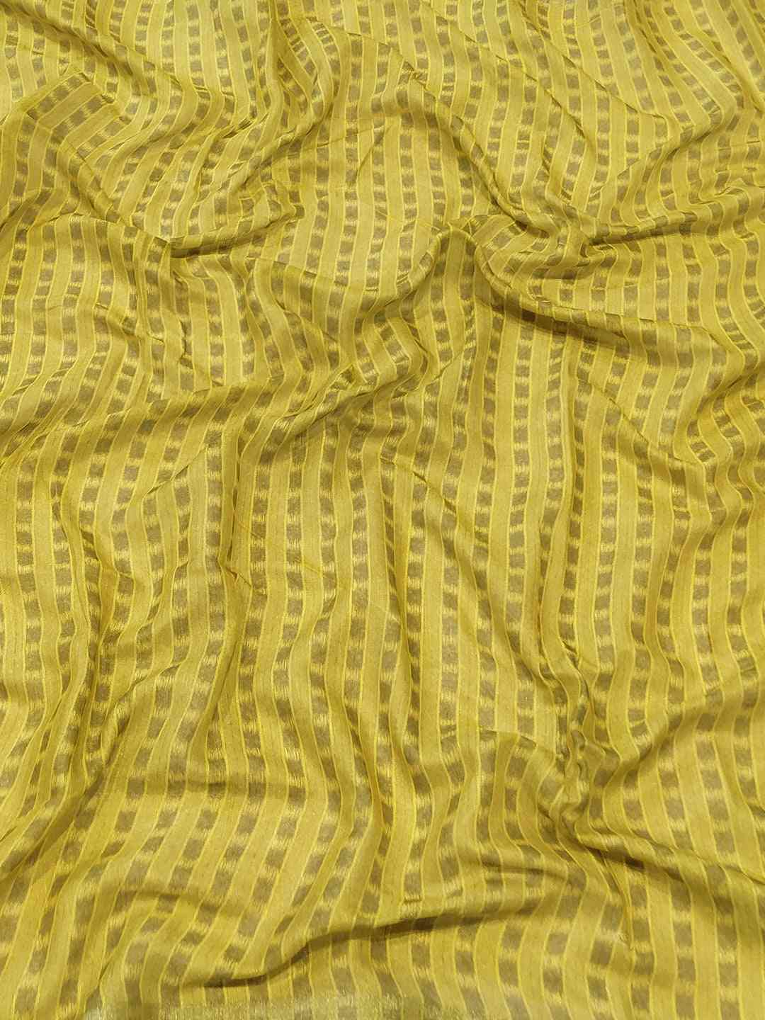 Close-up of yellow striped fabric from saree