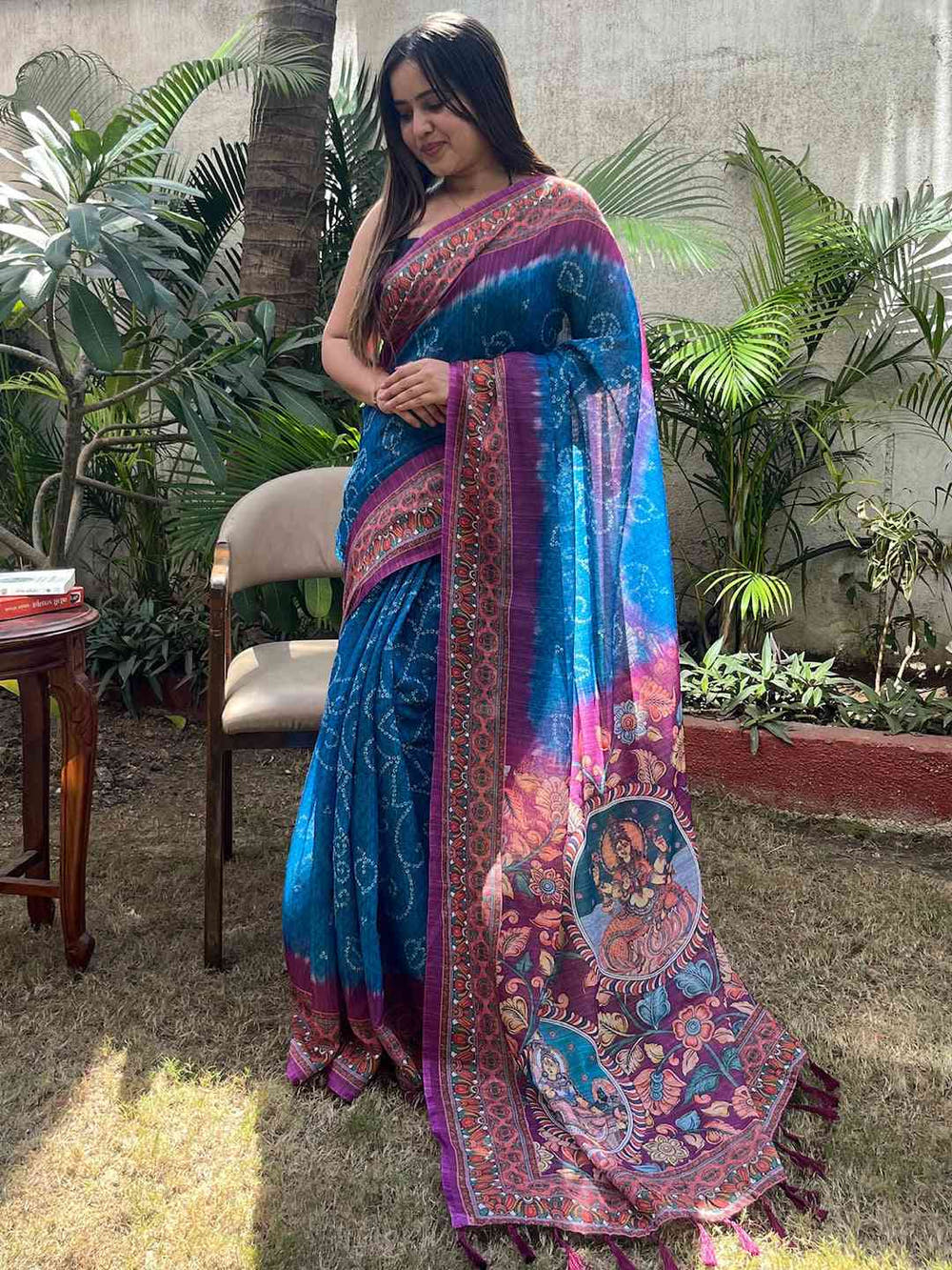 Elegant blue saree with Bandhej and Kalamkari print, standing