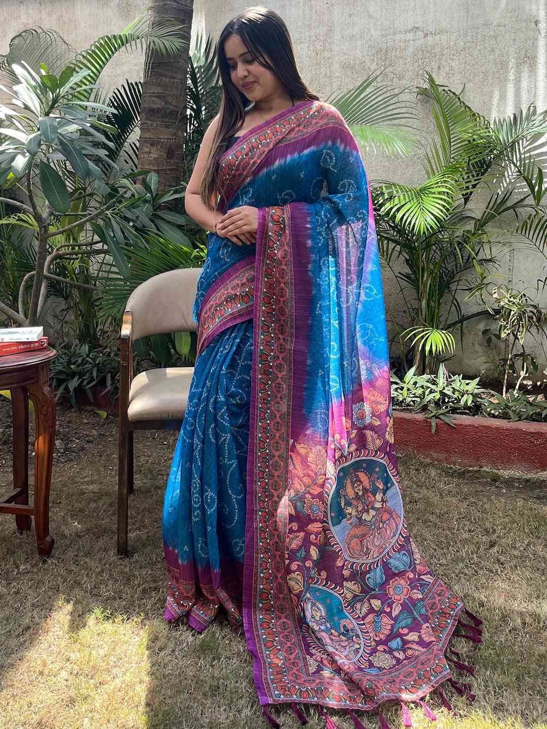 Elegant blue saree with Bandhej and Kalamkari print, standing