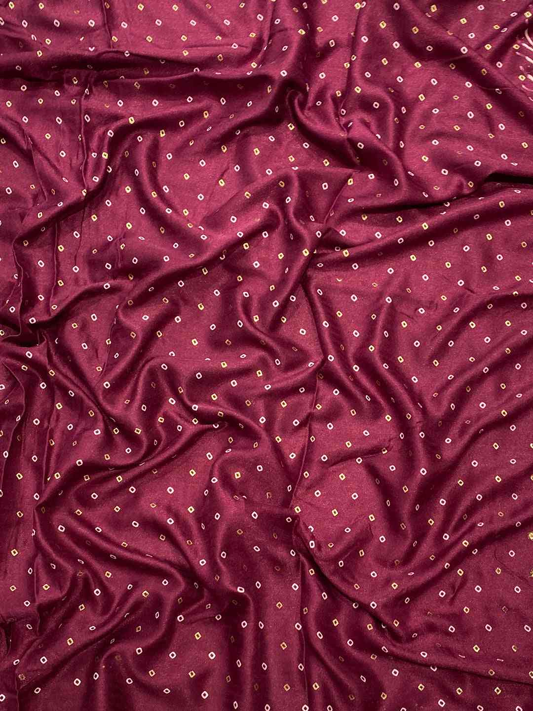 Close-up of Burgundy Manipuri Silk Saree fabric with foil print