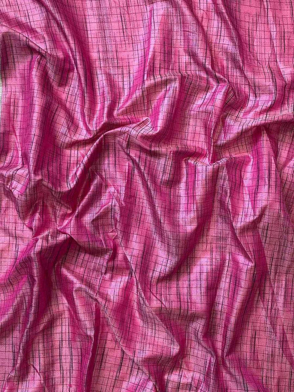 Close-up of pink silk fabric with intricate pattern