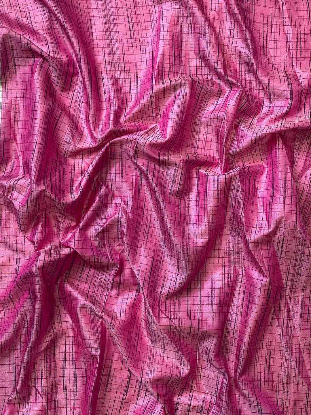 Close-up of pink silk fabric with intricate pattern