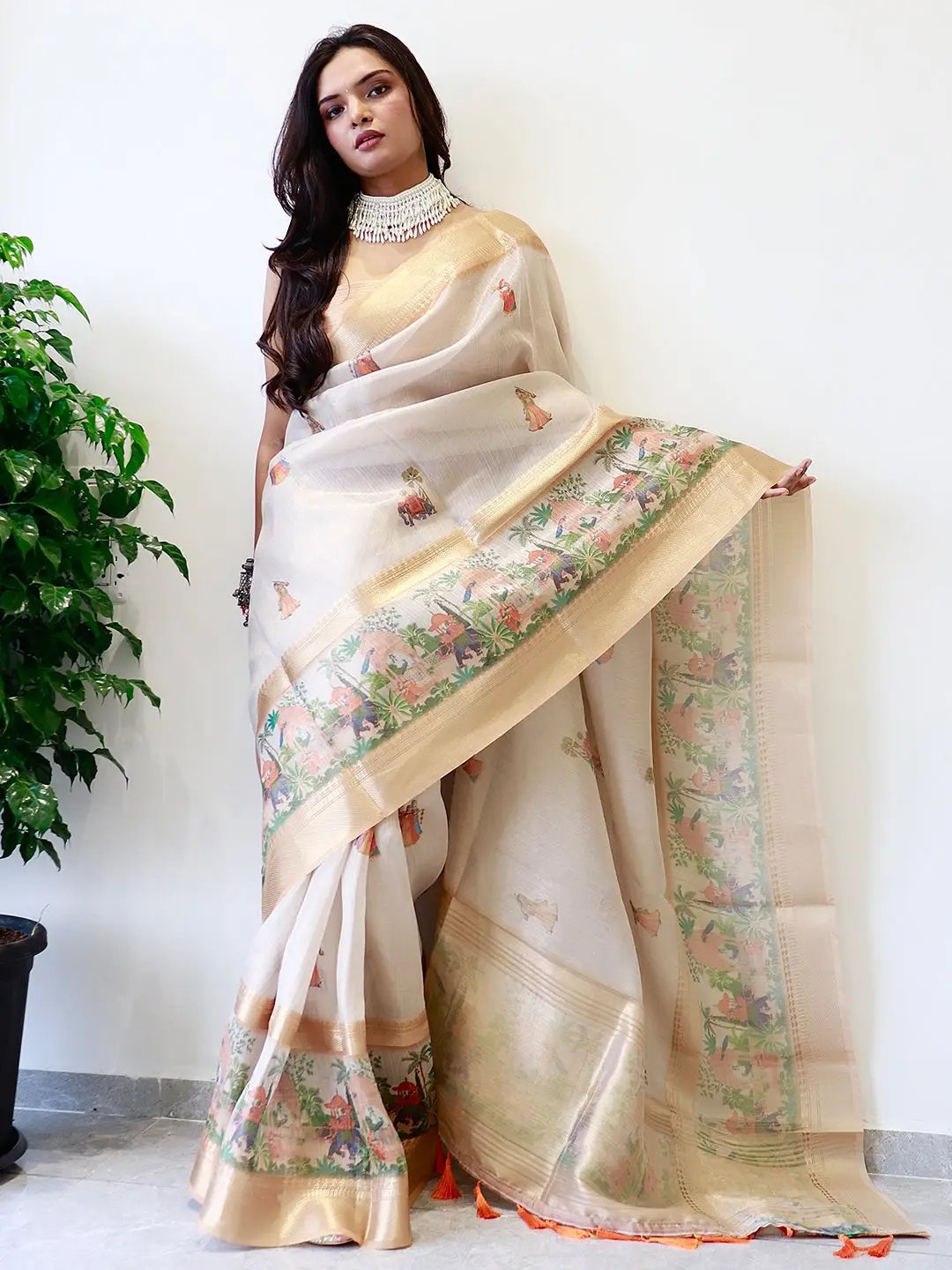 Elegant tissue saree featuring gold zari and digital prints