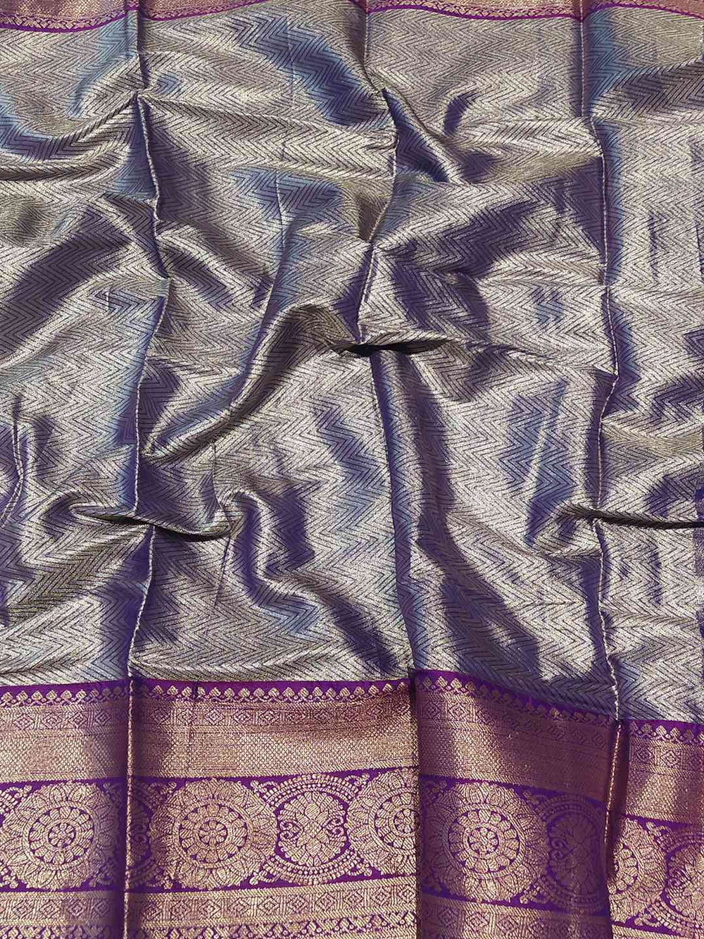 Detailed view of purple tissue silk saree fabric