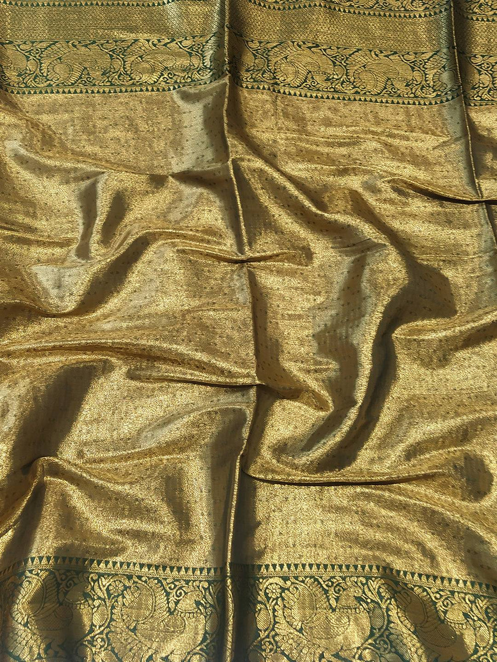 Close-up of gold Banarasi saree fabric with ornate design