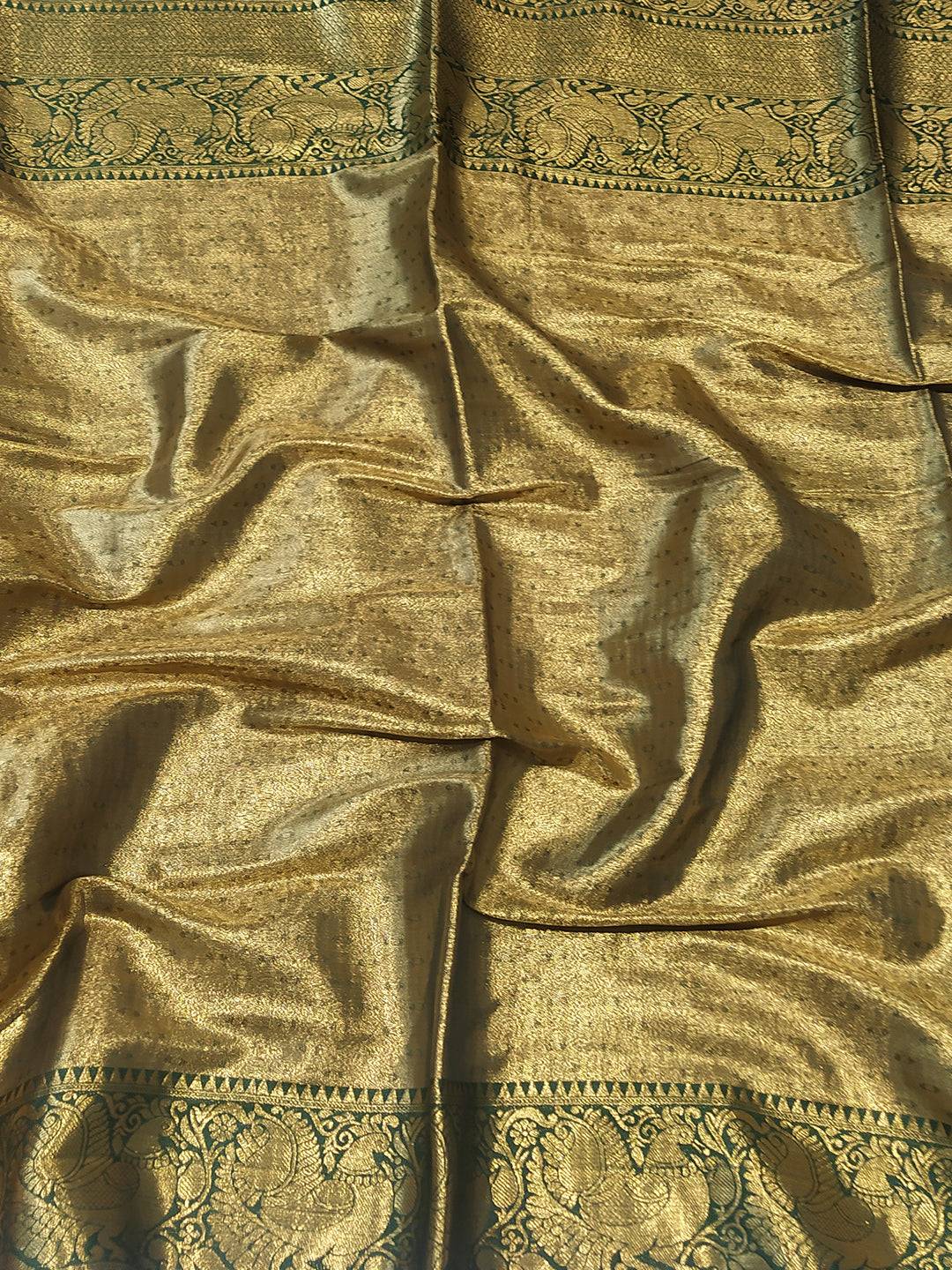 Close-up of gold Banarasi saree fabric with ornate design