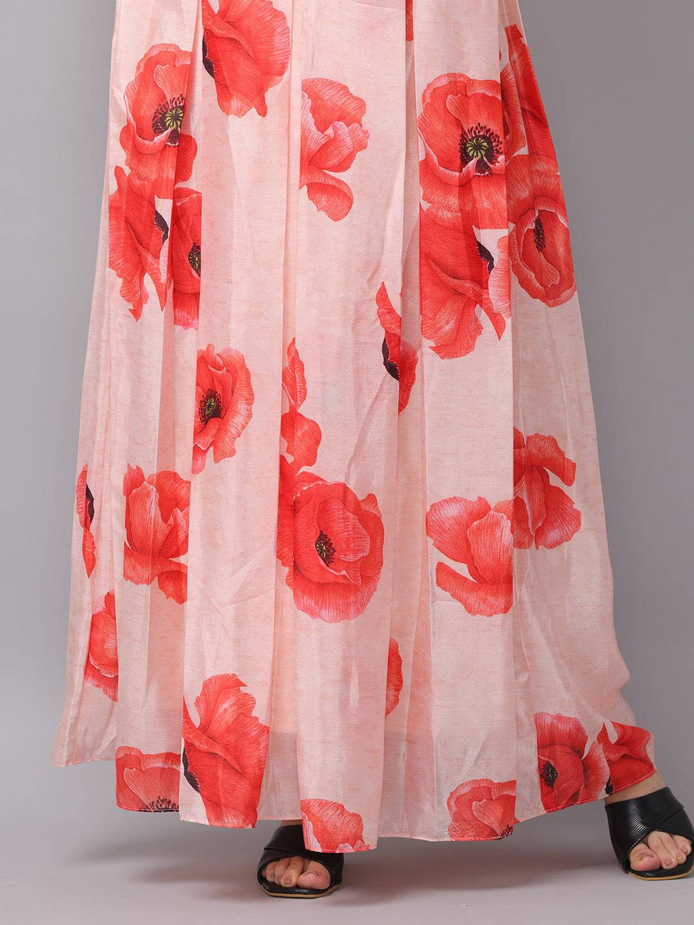 Hem detail of blush pink dress with red floral print
