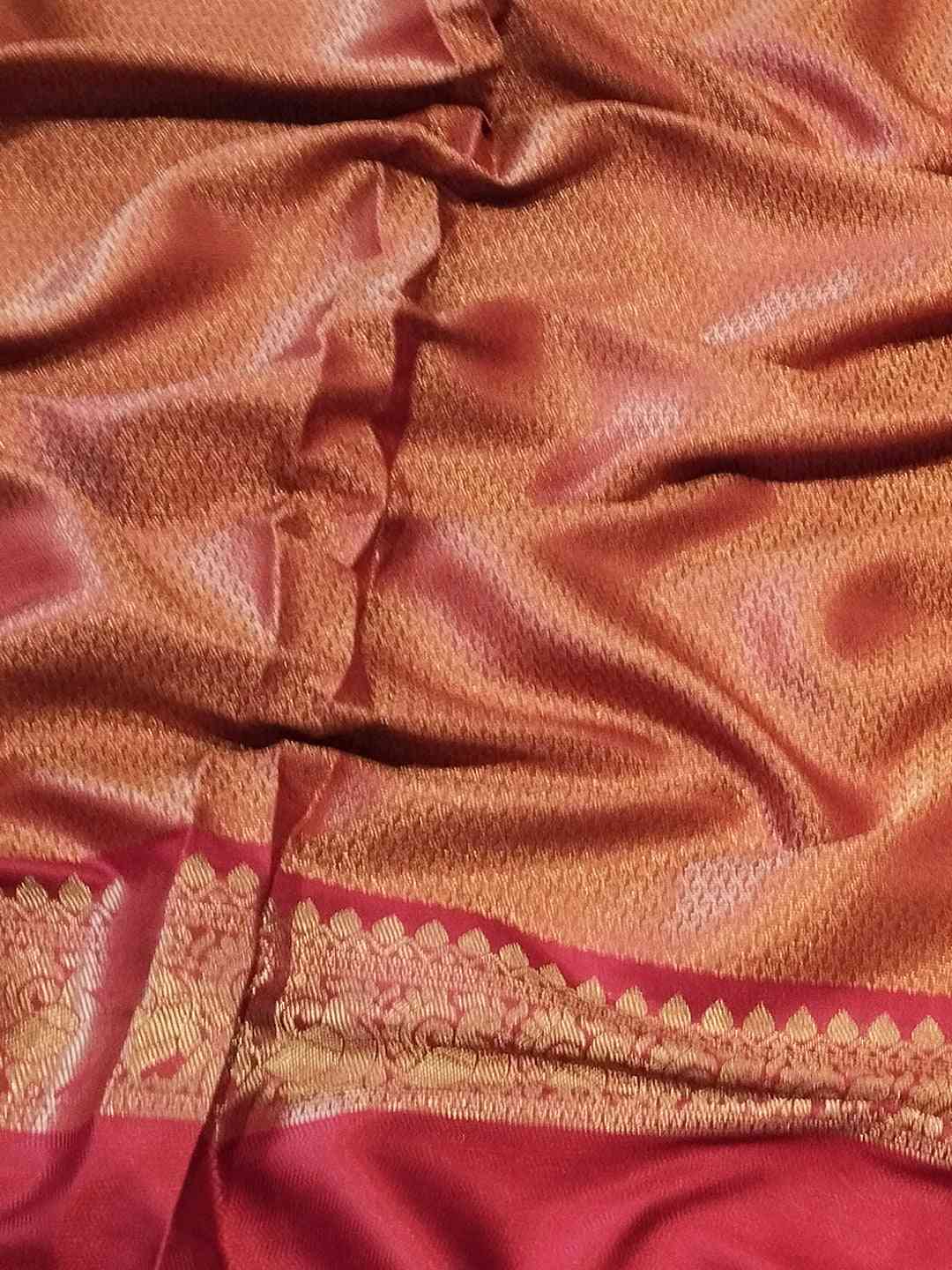 Detailed view of Banarasi saree fabric with gold border and patterns